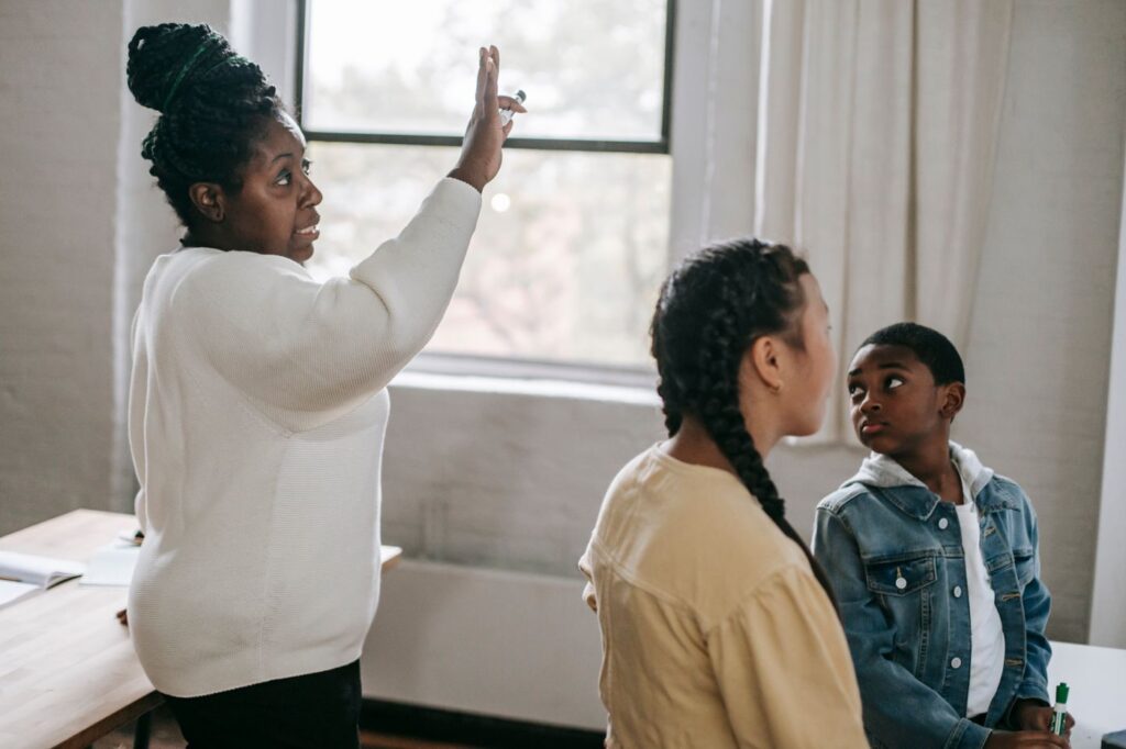 A teacher and young people exploring ideas together